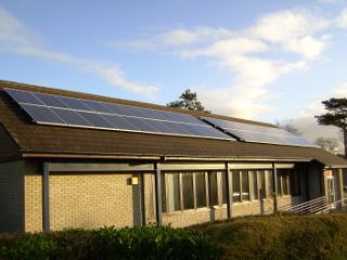 Solar panels along the roof of a long single-storey building